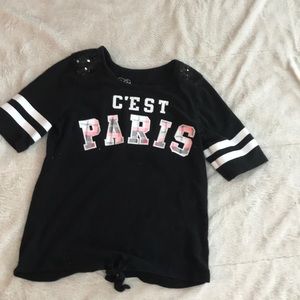 Black shirt, “c’est paris,” sequined shoulders.